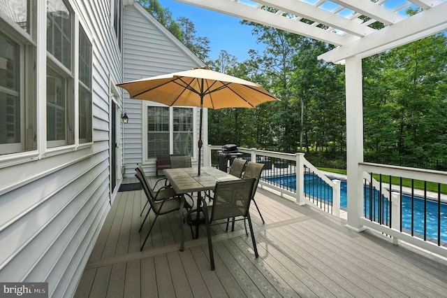 11220 Chivalry Chase Ln, Spotsylvania, VA 22551 - wooden terrace featuring an outdoor pool, a pergola, outdoor dining space, and view of scattered trees