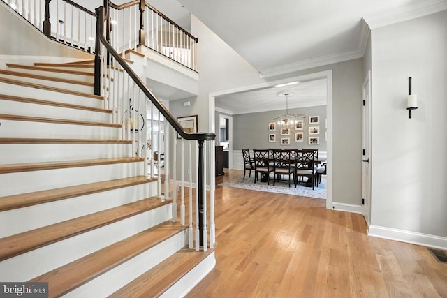 11220 Chivalry Chase Ln, Spotsylvania, VA 22551 - entryway with wood finished floors, stairway, and crown molding