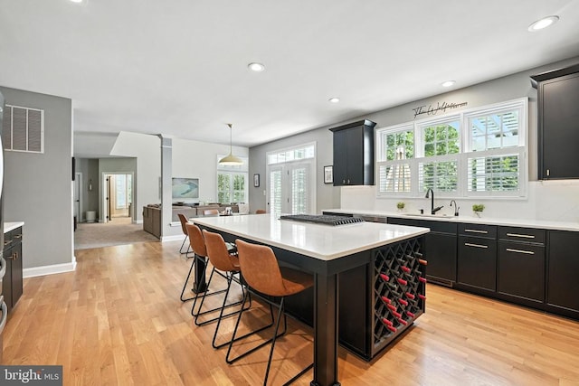 11220 Chivalry Chase Ln, Spotsylvania, VA 22551 - kitchen with light countertops, light wood-style flooring, a center island, and recessed lighting