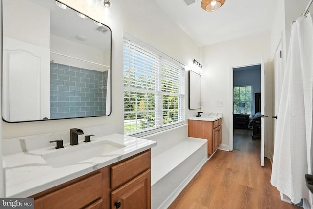 11220 Chivalry Chase Ln, Spotsylvania, VA 22551 - full bath featuring wood finished floors, two vanities, ensuite bathroom, and a shower with shower curtain