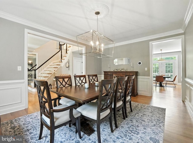 11220 Chivalry Chase Ln, Spotsylvania, VA 22551 - dining room with a chandelier, stairway, wood finished floors, ornamental molding, and wainscoting