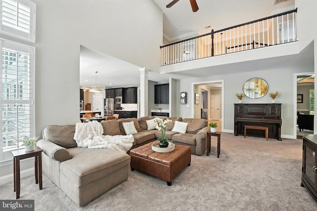 11220 Chivalry Chase Ln, Spotsylvania, VA 22551 - living room with a towering ceiling, ceiling fan, light carpet, and ornate columns