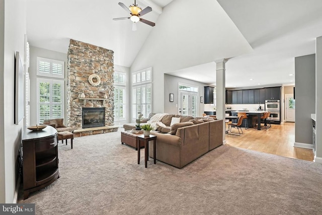 11220 Chivalry Chase Ln, Spotsylvania, VA 22551 - living area with light carpet, plenty of natural light, a stone fireplace, a ceiling fan, and high vaulted ceiling