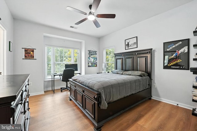 11220 Chivalry Chase Ln, Spotsylvania, VA 22551 - bedroom with multiple windows, wood finished floors, a desk, and ceiling fan