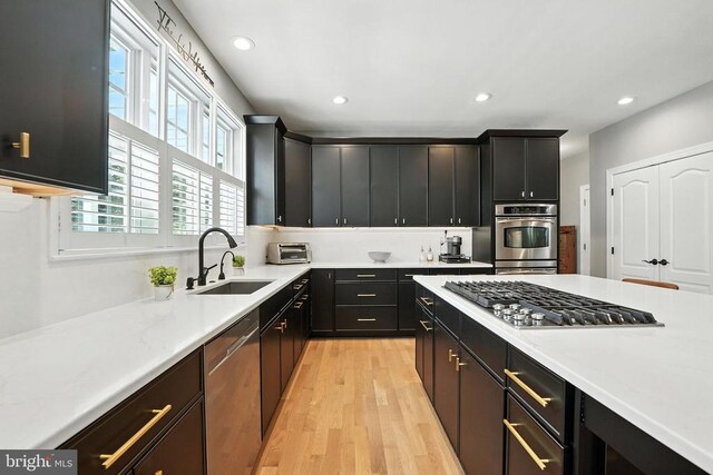 11220 Chivalry Chase Ln, Spotsylvania, VA 22551 - kitchen with stainless steel appliances, light wood-type flooring, recessed lighting, light countertops, and dark cabinetry