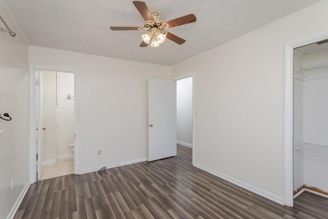508 Stuart Ave N, Elkton, VA 22827 - unfurnished bedroom featuring wood finished floors, a textured ceiling, crown molding, a closet, and connected bathroom