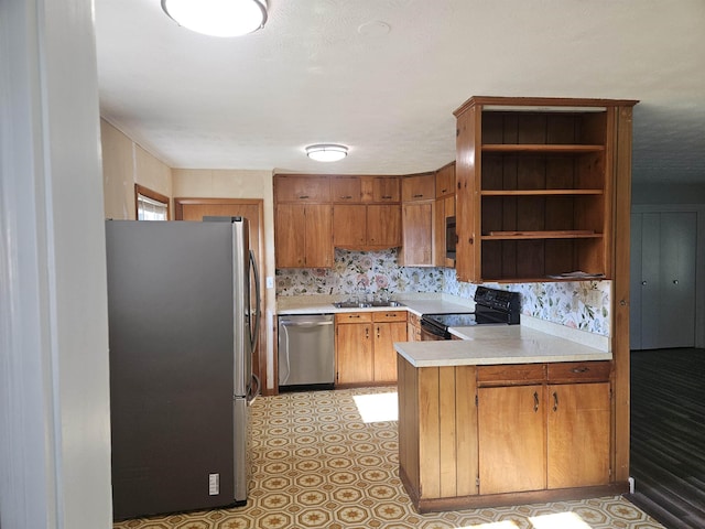 508 Stuart Ave N, Elkton, VA 22827 - kitchen featuring stainless steel appliances, a peninsula, light countertops, brown cabinetry, and open shelves