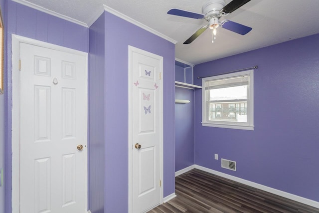 508 Stuart Ave N, Elkton, VA 22827 - unfurnished bedroom featuring dark wood-type flooring, crown molding, ceiling fan, and a textured ceiling