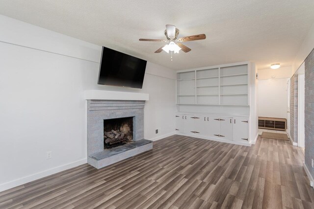 508 Stuart Ave N, Elkton, VA 22827 - unfurnished living room with ceiling fan, wood finished floors, a brick fireplace, and a textured ceiling