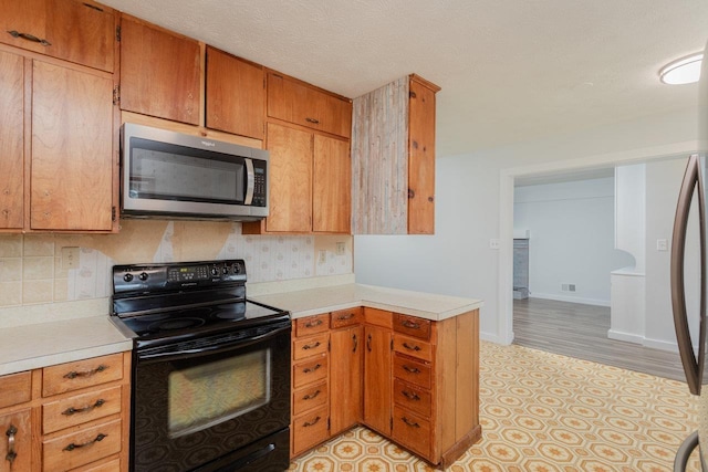 508 Stuart Ave N, Elkton, VA 22827 - kitchen featuring stainless steel microwave, electric range, light countertops, and backsplash