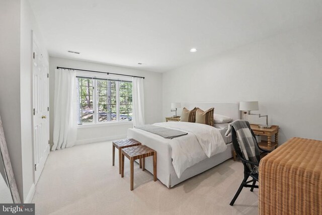  - bedroom featuring light colored carpet and baseboards