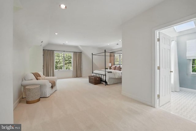  - bedroom featuring carpet, a skylight, vaulted ceiling, baseboards, and multiple windows