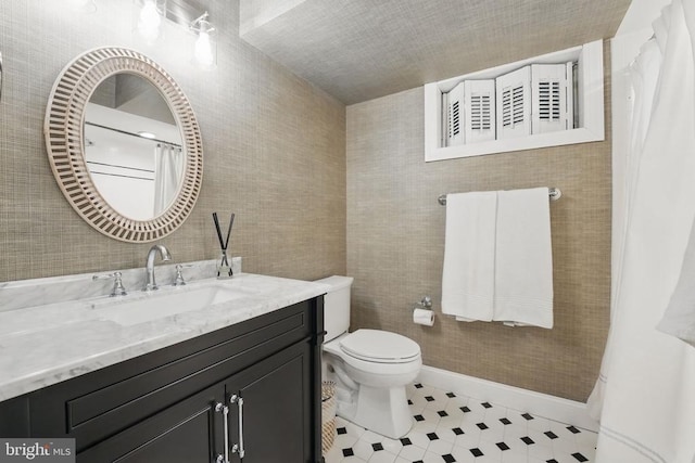  - full bathroom with vanity, toilet, and baseboards