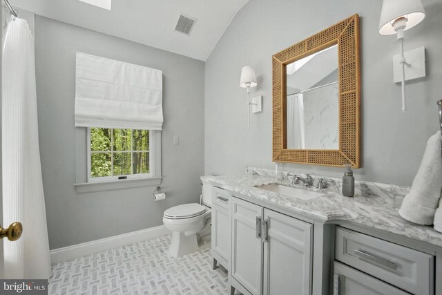 - full bathroom featuring lofted ceiling, baseboards, vanity, toilet, and curtained shower