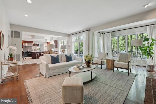  - living area with wood finished floors and recessed lighting