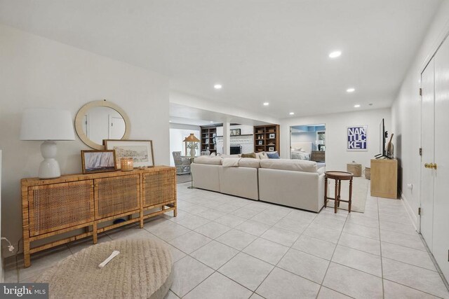  - living area with light tile patterned flooring, recessed lighting, and a fireplace