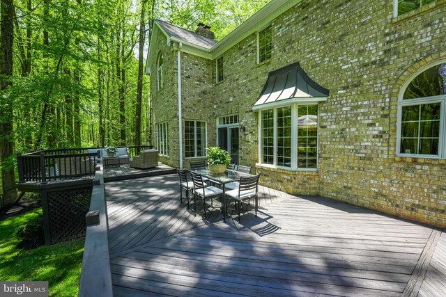 - wooden terrace featuring outdoor dining area and outdoor lounge area