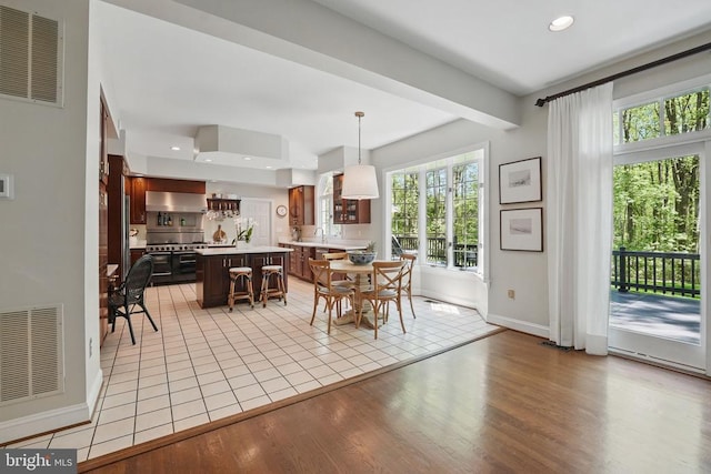  - dining space featuring light wood-style floors, baseboards, and recessed lighting