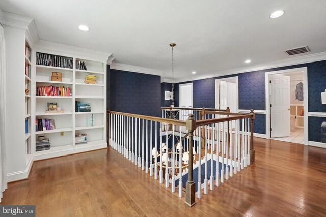  - corridor featuring wallpapered walls, crown molding, wood finished floors, an upstairs landing, and recessed lighting