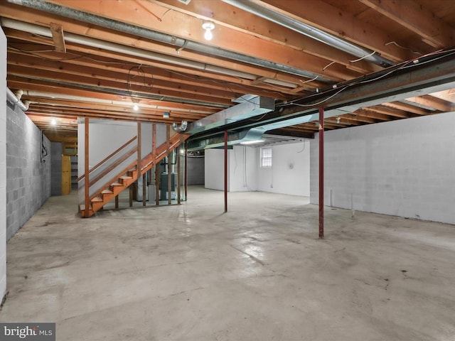  - basement featuring stairway and concrete block wall