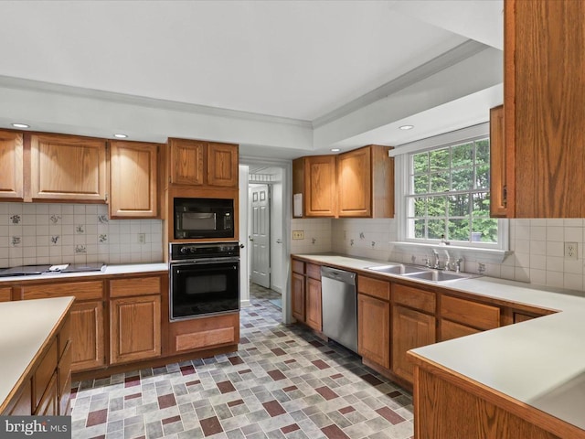  - kitchen with black appliances, light countertops, backsplash, ornamental molding, and brown cabinets