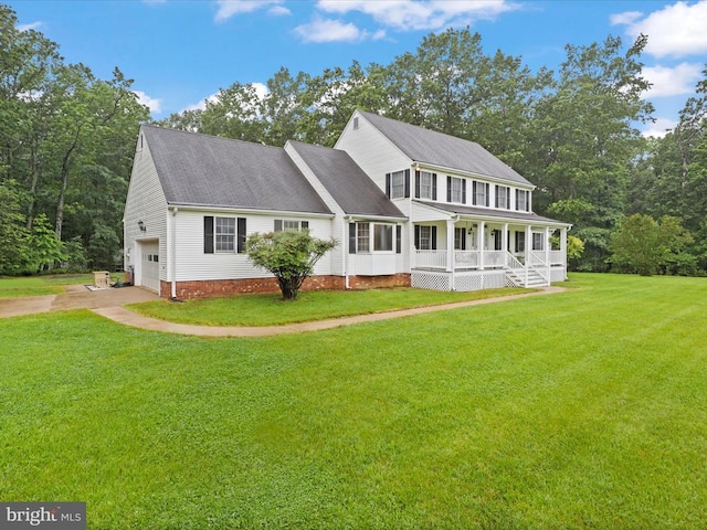  - colonial home featuring a porch, a garage, a front yard, driveway, and roof with shingles