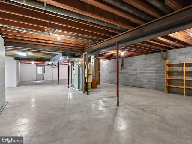  - basement featuring concrete block wall and heating unit