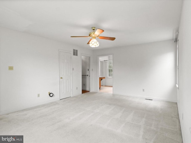  - unfurnished room featuring a ceiling fan and light colored carpet
