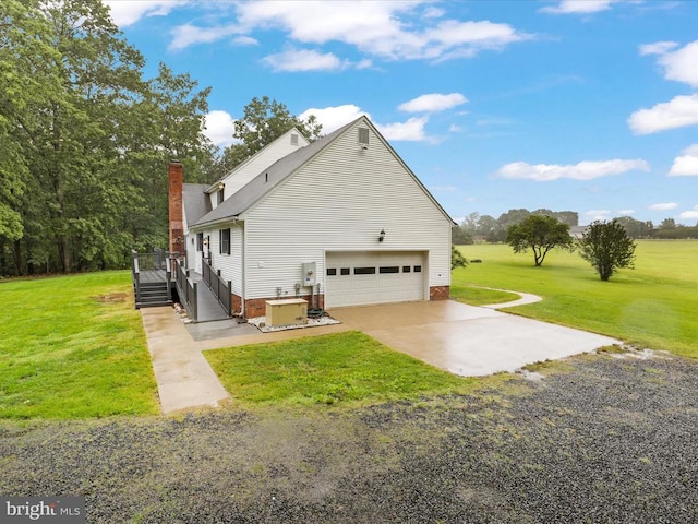  - view of property exterior with a yard, concrete driveway, a chimney, and a wooden deck