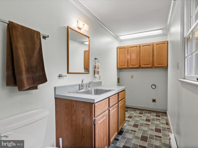  - half bath with vanity, crown molding, and baseboard heating