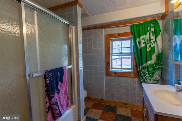 18075 Safe Haven Way, Culpeper, VA 22701 - full bathroom with tile walls, vanity, a textured ceiling, and toilet