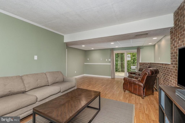 6217 Oak Grove Dr, Fredericksburg, VA 22407 - living area with light wood-style floors, ornamental molding, a textured ceiling, and a brick fireplace