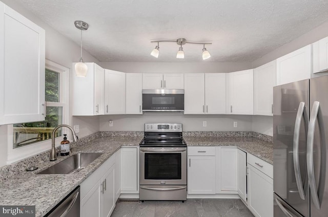 6217 Oak Grove Dr, Fredericksburg, VA 22407 - kitchen featuring stainless steel appliances, white cabinetry, light marble finish flooring, and light stone countertops