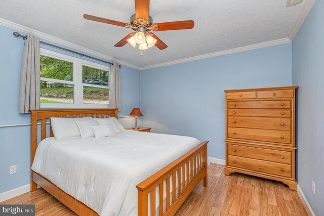 6217 Oak Grove Dr, Fredericksburg, VA 22407 - bedroom featuring light wood finished floors, ornamental molding, a textured ceiling, and ceiling fan