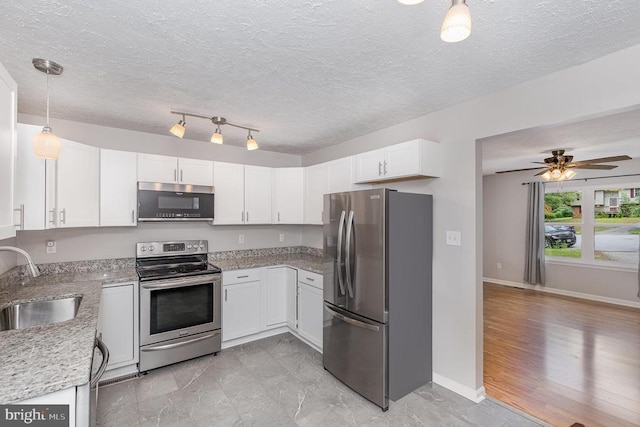 6217 Oak Grove Dr, Fredericksburg, VA 22407 - kitchen featuring stainless steel appliances, white cabinetry, light stone counters, ceiling fan, and hanging light fixtures