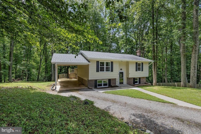 6217 Oak Grove Dr, Fredericksburg, VA 22407 - split foyer home featuring a chimney, gravel driveway, a carport, and brick siding