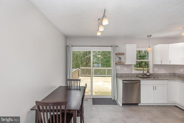 6217 Oak Grove Dr, Fredericksburg, VA 22407 - kitchen with stainless steel dishwasher, white cabinetry, a textured ceiling, hanging light fixtures, and light stone counters