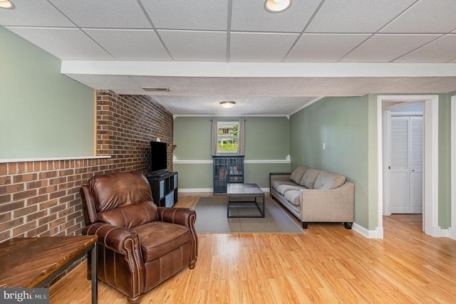6217 Oak Grove Dr, Fredericksburg, VA 22407 - living area featuring wood finished floors, brick wall, and a fireplace