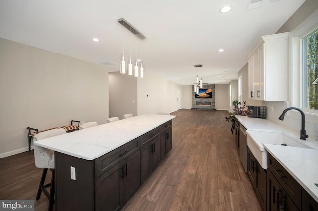 112 Edgehill Dr, Locust Grove, VA 22508 - kitchen with a kitchen bar, open floor plan, white cabinetry, dark wood-style floors, and a kitchen island