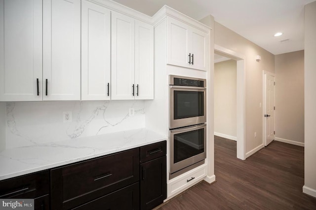112 Edgehill Dr, Locust Grove, VA 22508 - kitchen with stainless steel double oven, white cabinetry, dark wood finished floors, light stone countertops, and recessed lighting