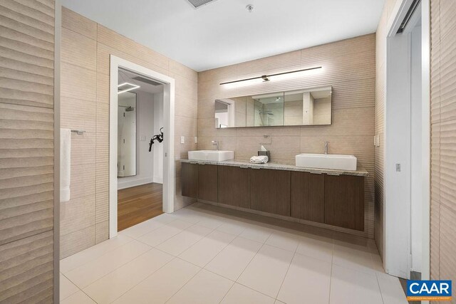 218 Water St W Unit 705, Charlottesville, VA 22902 - full bathroom featuring a sink, double vanity, a shower, and tile patterned flooring