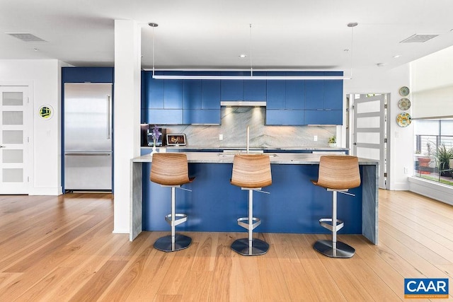 218 Water St W Unit 705, Charlottesville, VA 22902 - kitchen featuring built in refrigerator, backsplash, modern cabinets, and blue cabinets