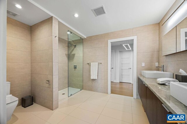 218 Water St W Unit 705, Charlottesville, VA 22902 - full bathroom featuring visible vents, a walk in shower, tile patterned flooring, and a sink