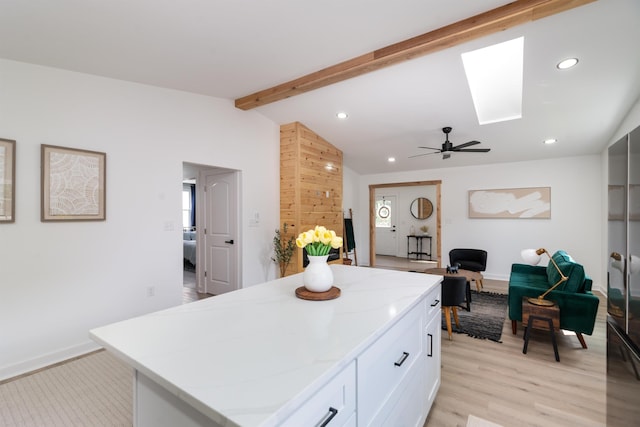 1401 B St, Waynesboro, VA 22980 - kitchen with a skylight, recessed lighting, a center island, light stone countertops, and white cabinets