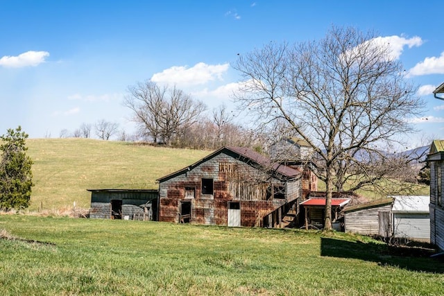 253 Church St, Timberville, VA 22853 - back of house featuring a yard, an outbuilding, and a barn