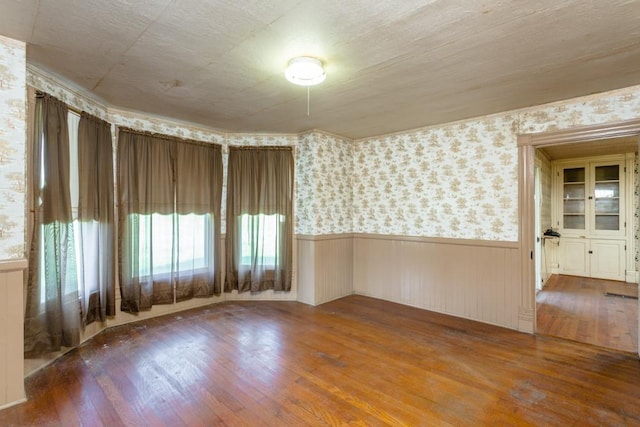 253 Church St, Timberville, VA 22853 - spare room with a wealth of natural light, hardwood / wood-style floors, wallpapered walls, and a wainscoted wall