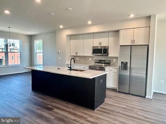 7861 Harlow Cir, Spotsylvania, VA 22551 - kitchen featuring stainless steel appliances, recessed lighting, tasteful backsplash, wood finished floors, and light countertops