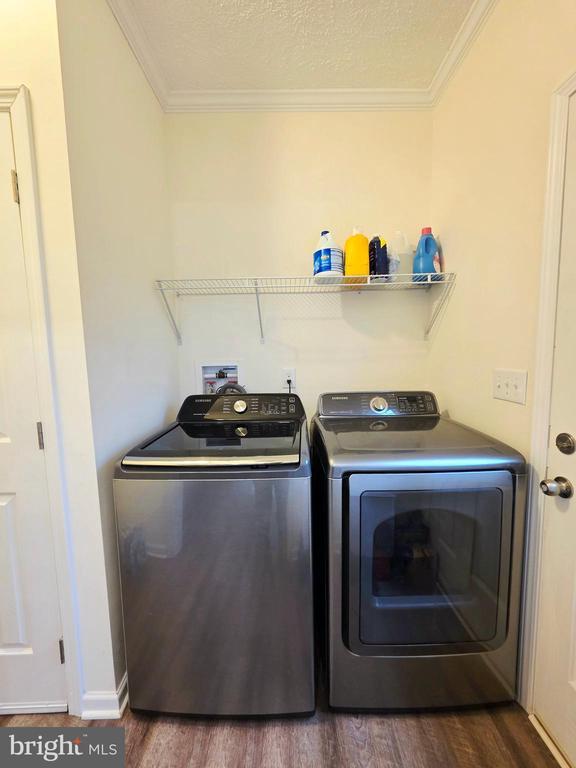 14511 Antler Rd, Fredericksburg, VA 22407 - clothes washing area featuring washer and clothes dryer, crown molding, wood finished floors, and baseboards