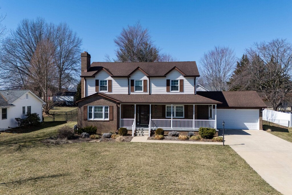 740 Jackson St, Woodstock, VA 22664 - view of front of property with a chimney, driveway, brick siding, fence, and a porch