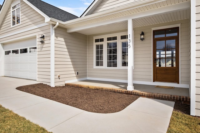 135 Radnor Ct, Rockingham, VA 22801 - property entrance featuring a porch, roof with shingles, an attached garage, and driveway